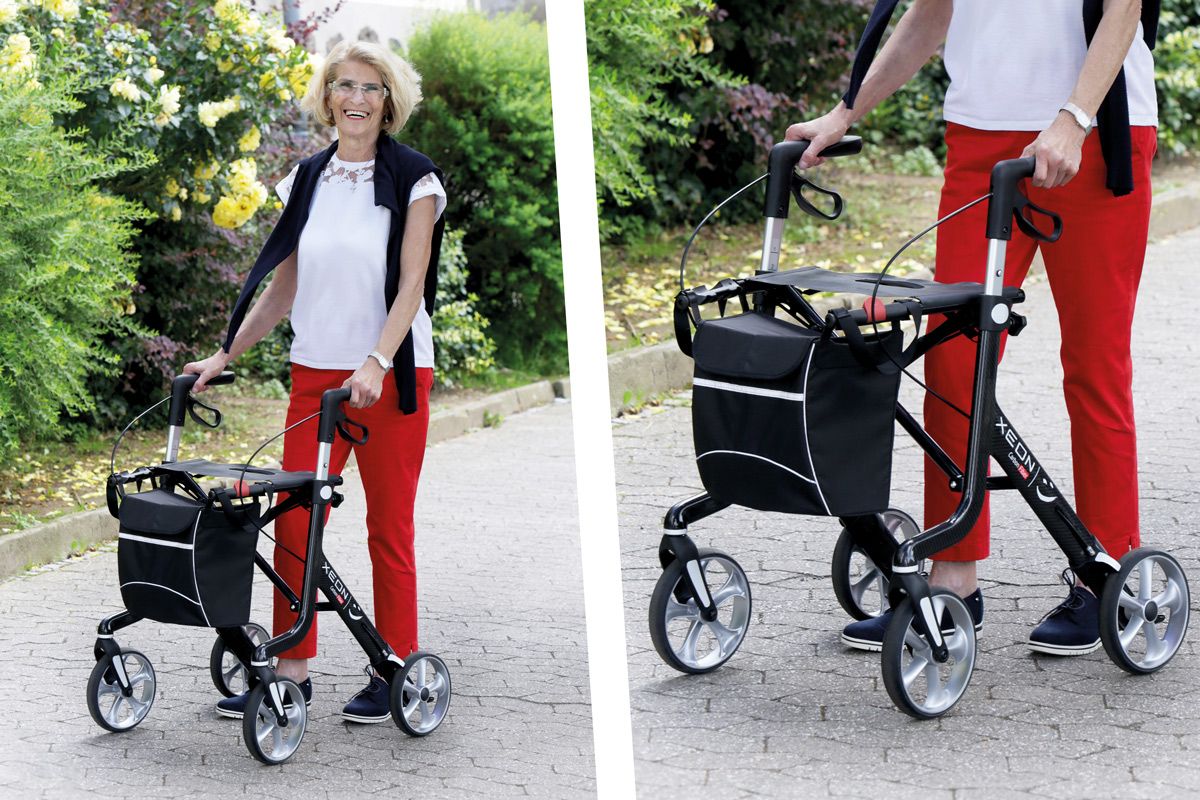Eine Frau spaziert mit dem Xeon Rollator Carbon durch den Park.